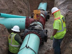 Workers installing pipe