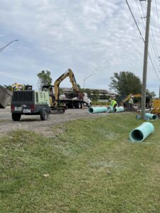 Construction crew installing pipe